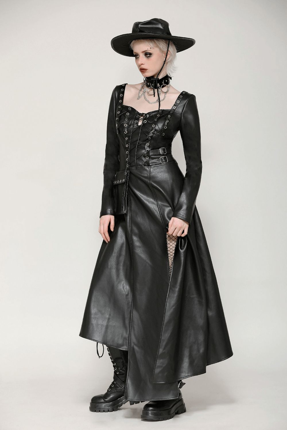 Dark aesthetics with a faux leather gothic dress featuring harness, grommets, long sleeves, and a stylish hat.