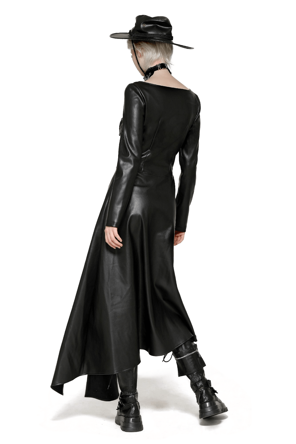 Model showcasing a faux leather gothic dress with long sleeves and an asymmetrical hemline, styled with a wide-brim hat.