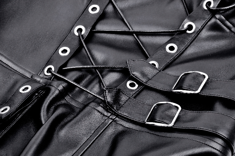 Close-up of intricate lace-up and buckle details on a black faux leather gothic dress with grommets.