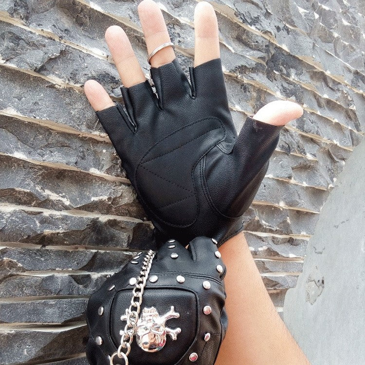 Faux leather half-finger gloves with skull detail and rivets, perfect for punk and goth style.