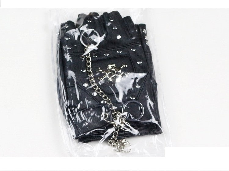 Faux leather half-finger gloves with metal skull and rivets in packaging, perfect for punk and goth fashion.
