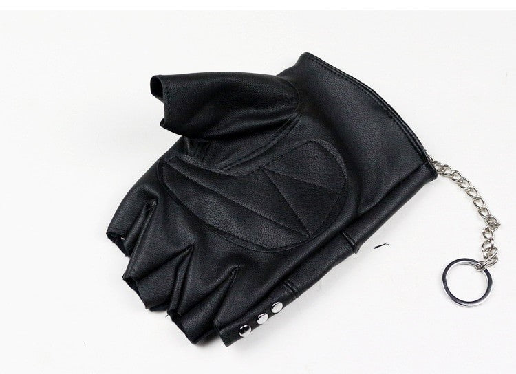 Faux leather half-finger gloves featuring skull detail, rivets, and chain; perfect for punk and goth style.