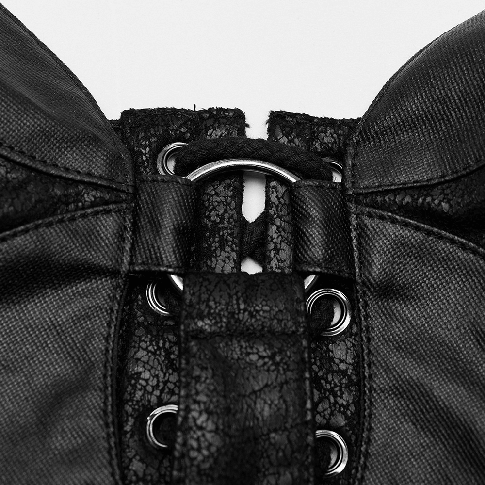 Close-up of black faux leather lace-up corset top with eyelet and hardware details.