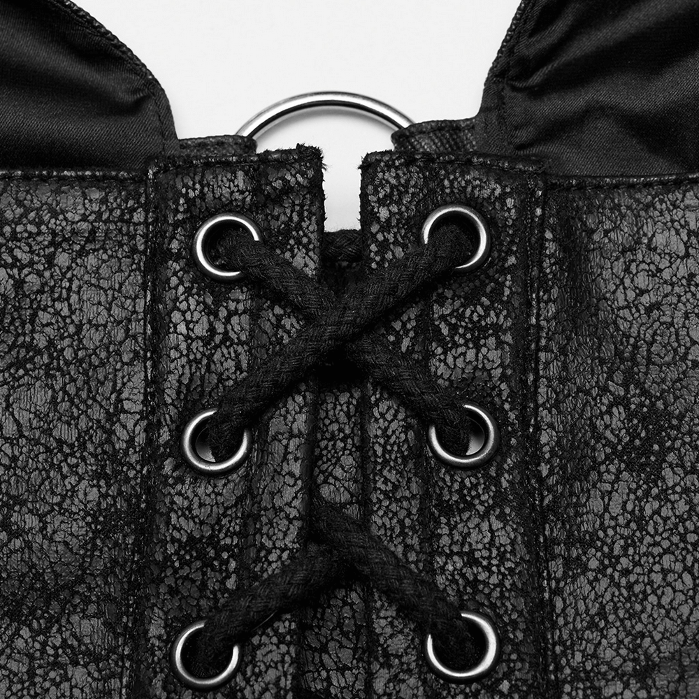 Close-up of black cracked faux leather corset top with eyelet lace-up details and metallic ring.