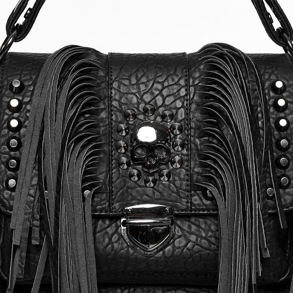 Black faux leather handbag with skull rivet and tassels, featuring punk-style fringe and metal zipper closure.