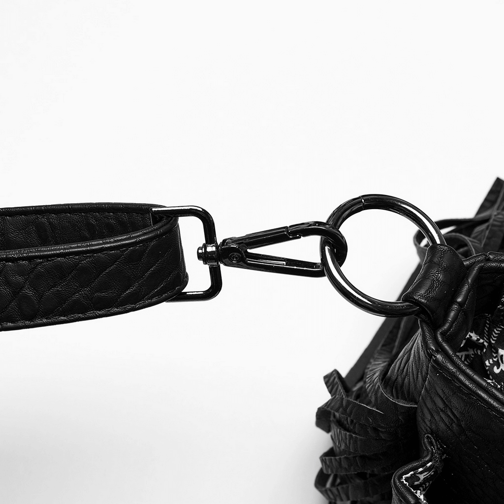 Close-up of the metal clasp connecting the strap to the faux leather skull handbag, showcasing its edgy design.