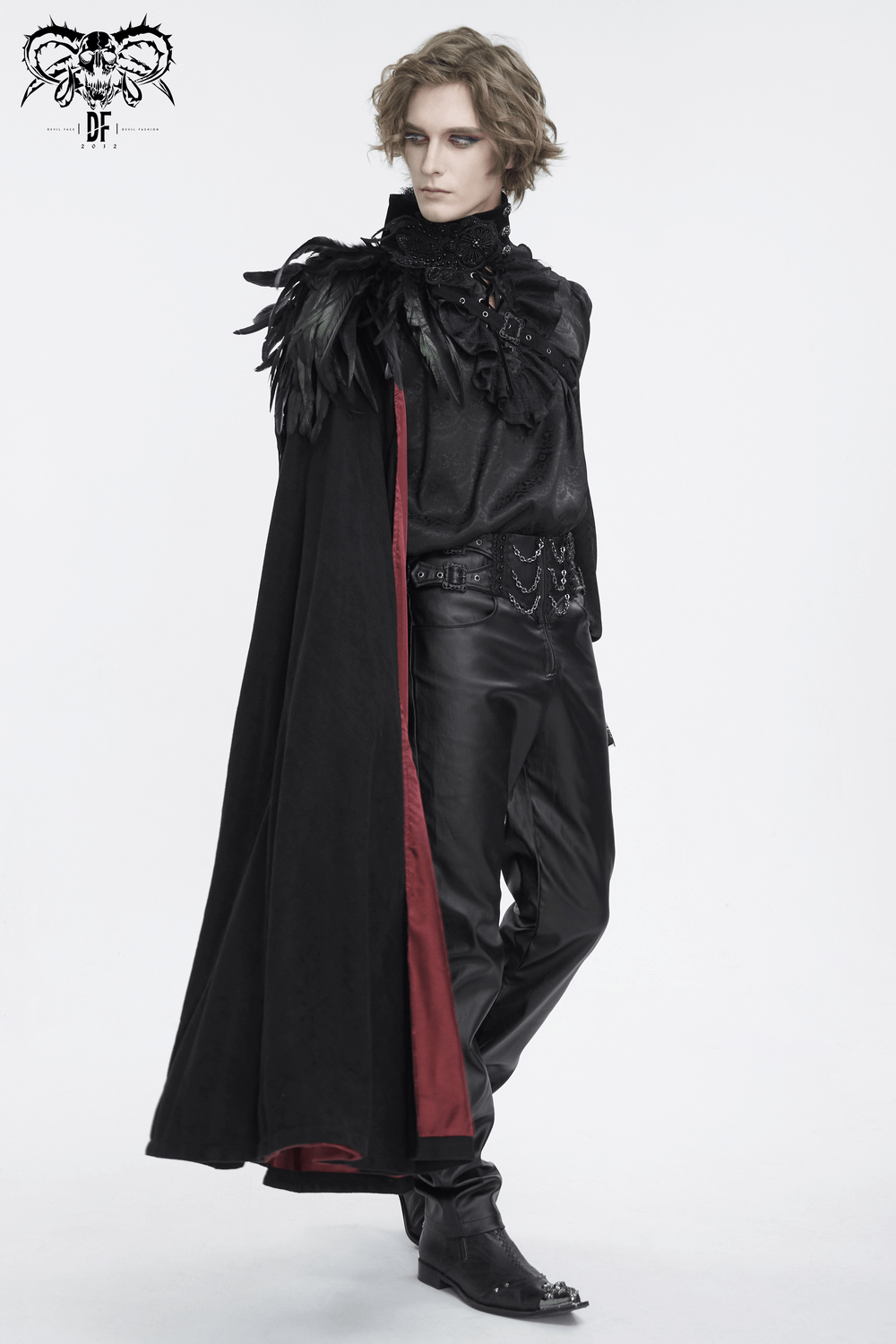 Stylish model wearing a black asymmetric cape with feather accents, perfect for evening glam at upscale events.