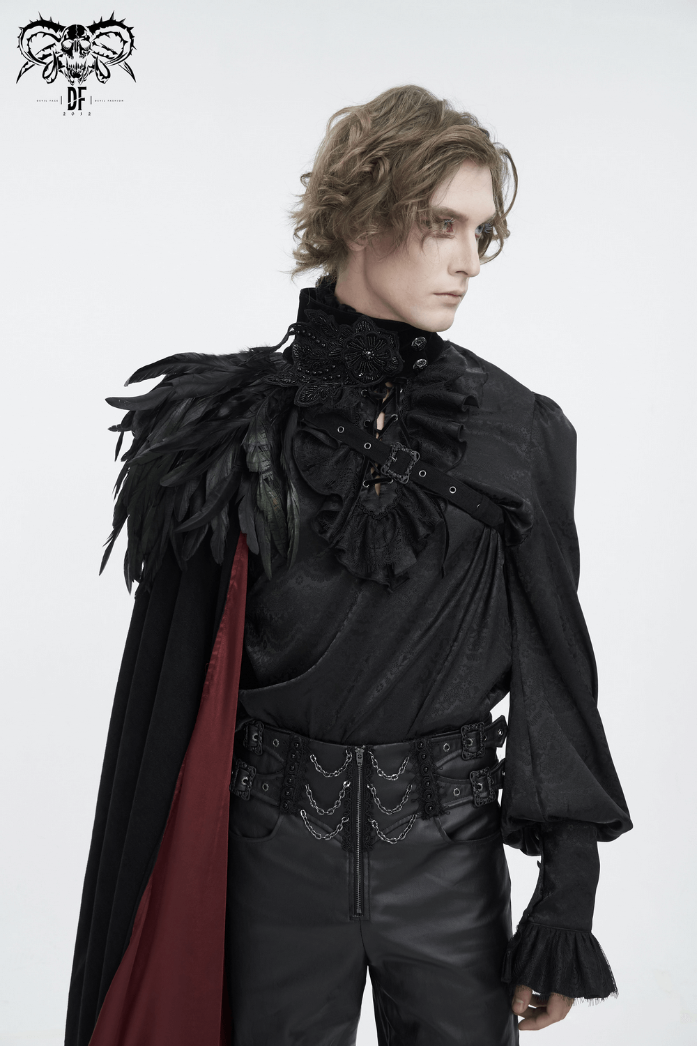 Elegant model in black asymmetric cape with feather accents, perfect for evening glam and making a fashion statement.