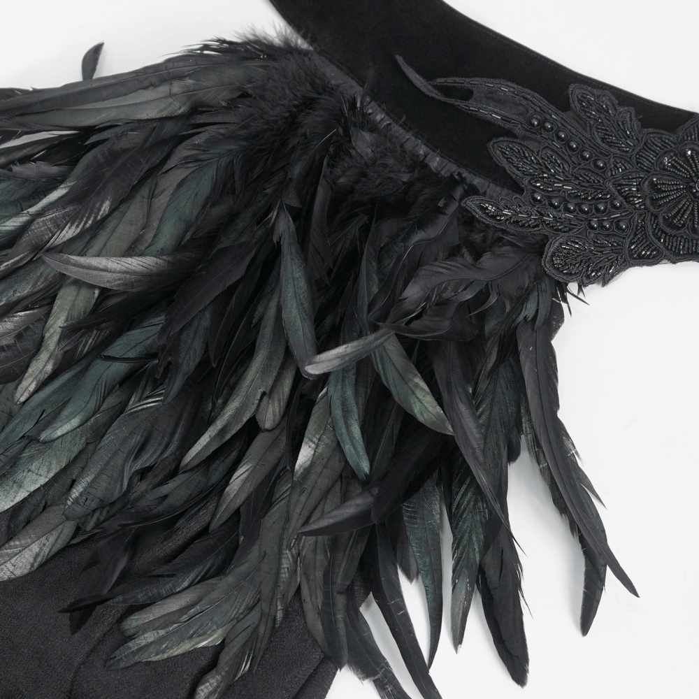 Elegant black asymmetric cape showcasing stunning feather accents and intricate bead work for evening glamour.