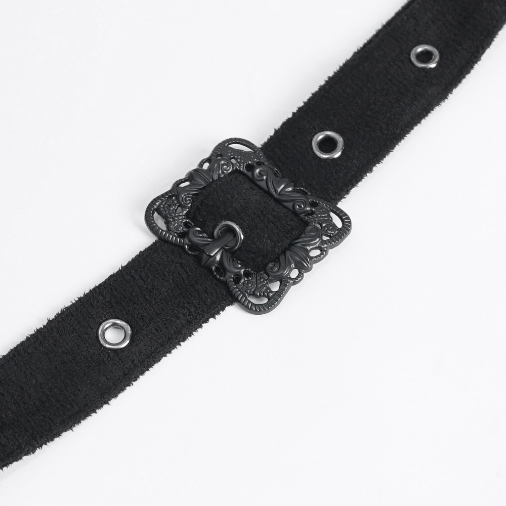 Black suede belt with ornate floral buckle and eyelet details for a stylish accessory.