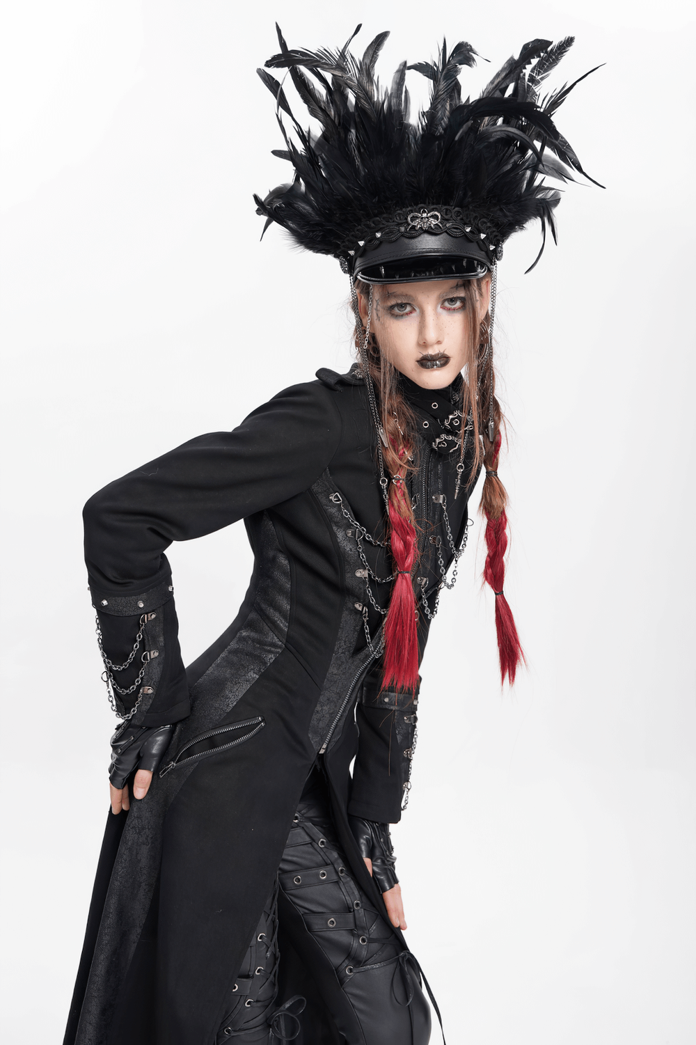 Gothic model wearing a feathered leather cap with lace and chains, styled in alternative fashion.