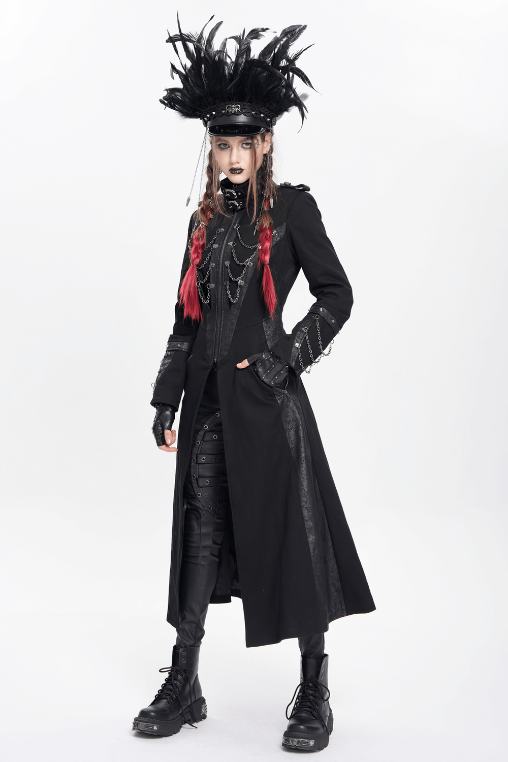 Gothic model in black feathered cap, layered coat, and chains, showcasing alternative fashion at its best.