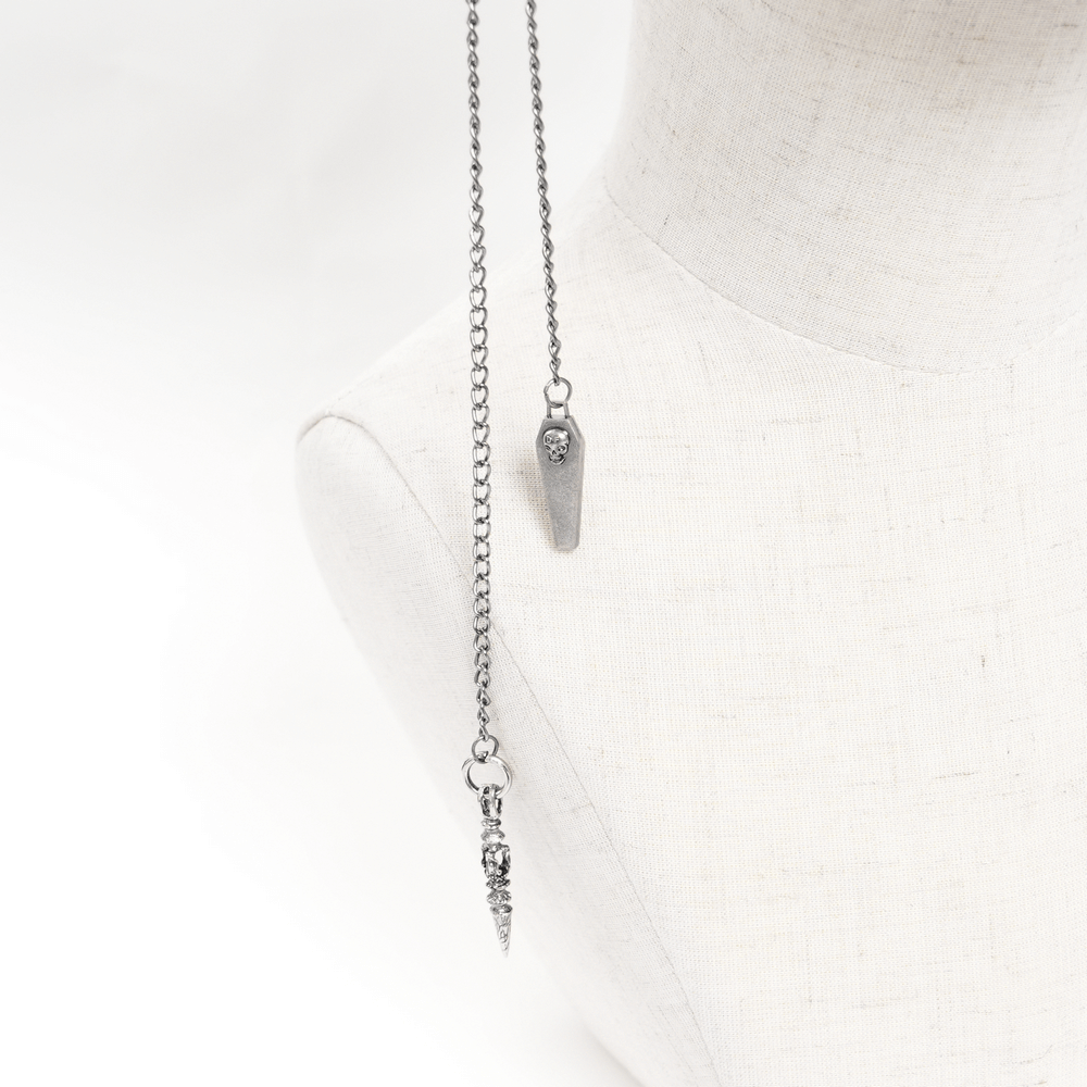 Gothic silver chain pendant necklace featuring coffin and spike charms for alternative fashion lovers.