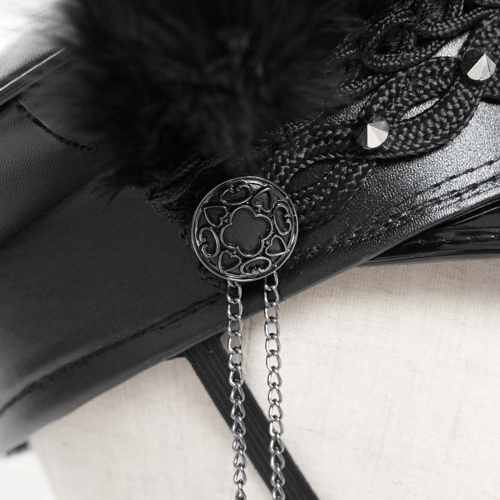 Close-up of gothic leather cap's lace and chain details with feather embellishments.