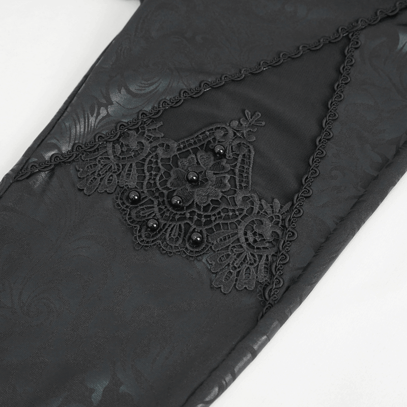 Close-up of black embroidered leggings with lace and bead details, showcasing gothic elegance and unique splice design.