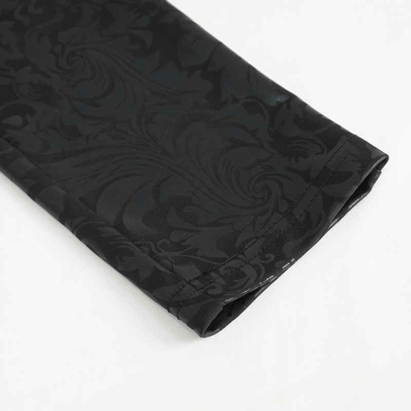 Close-up of female black embroidered leggings showcasing gothic patterns and intricate details.