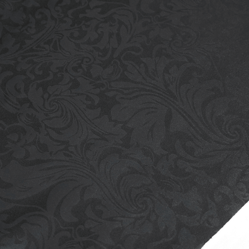Elegant black fabric with intricate swirling floral patterns, perfect for gothic decor or fashion.