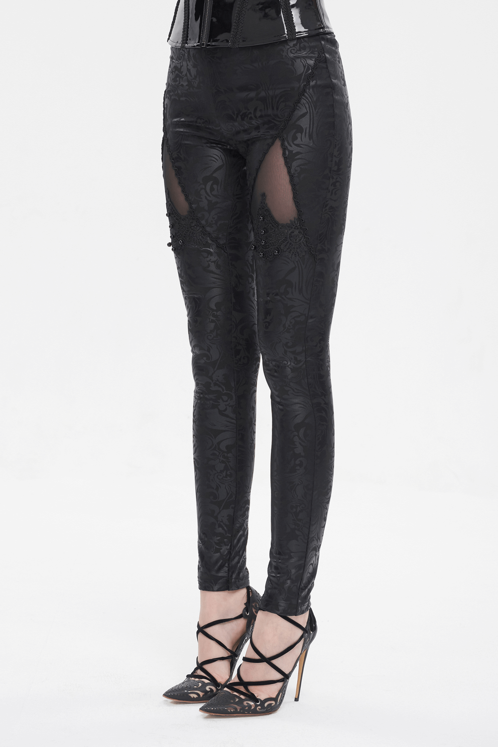 Female Black Embroidered Splice Leggings / Gothic Decorated Beads Pants showcased on model in black high heels.