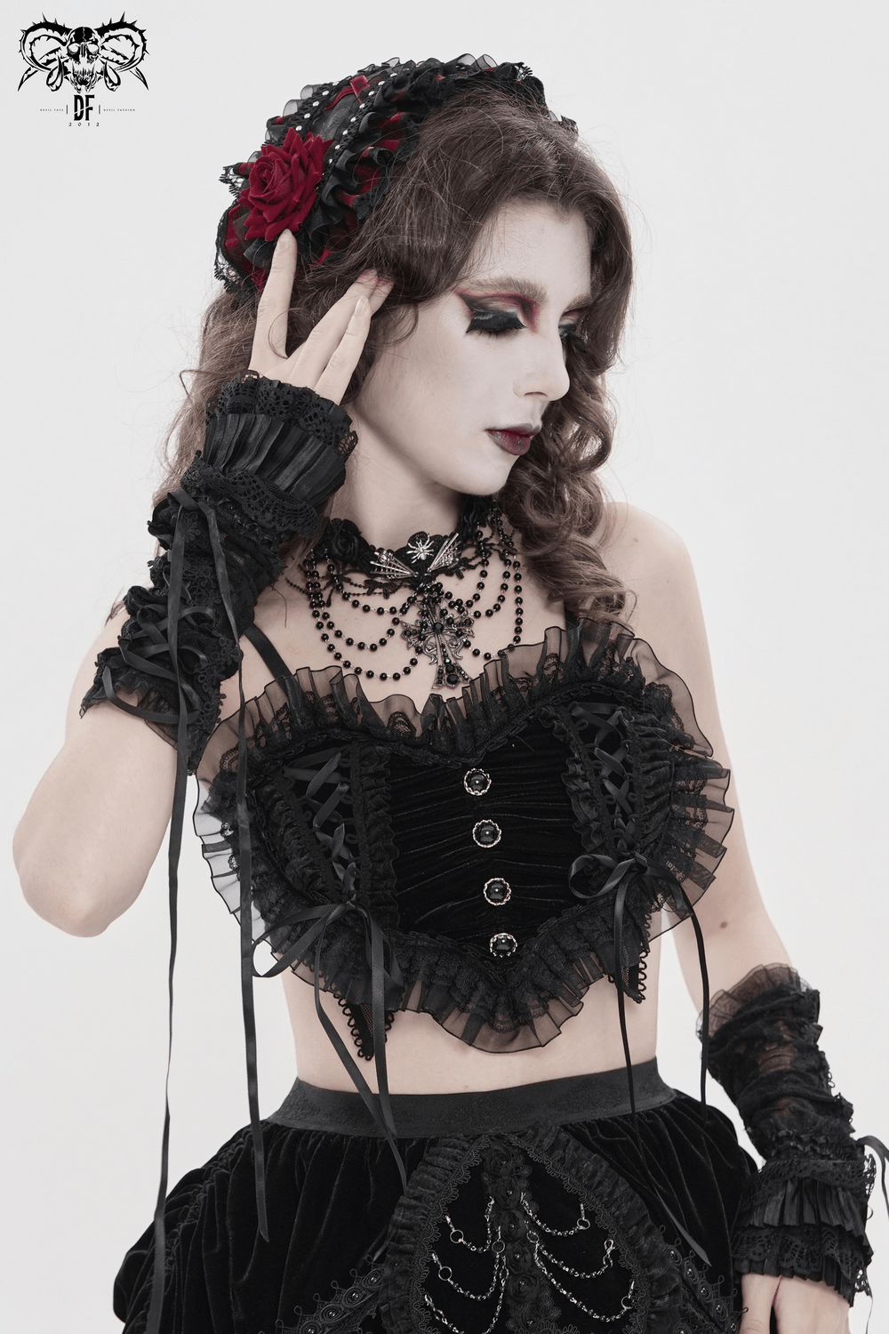 Female Black Lace Crop Top with Ruffle Trim Detail worn with gothic accessories, layered ruffles, and dramatic makeup.