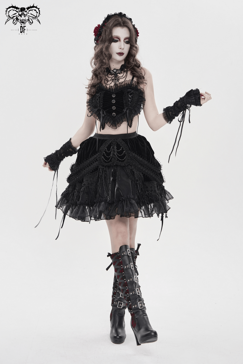 Female Black Lace Crop Top with Ruffle Trim Detail worn with a gothic skirt and accessories, showcasing dramatic fashion style.