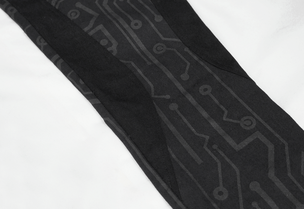 Close-up of black skinny pants with a stylish cyberpunk circuit print, perfect for creating trendy outfits.