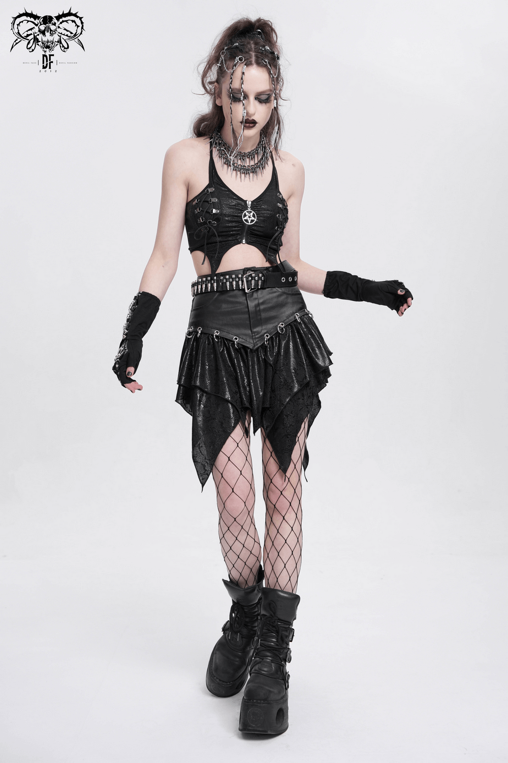 Edgy female model in sleeveless black crop top with pentagram, layered skirt, and fishnet tights. Perfect for punk style!