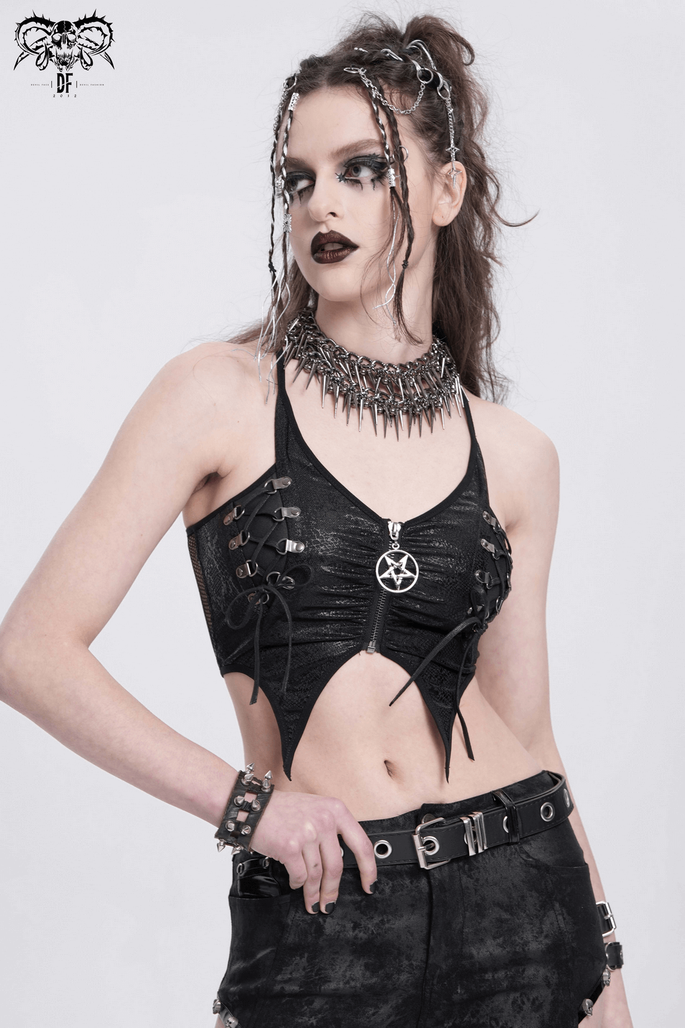 Edgy female crop top featuring a pentagram and straps, perfect for punk fashion enthusiasts and festival lovers.