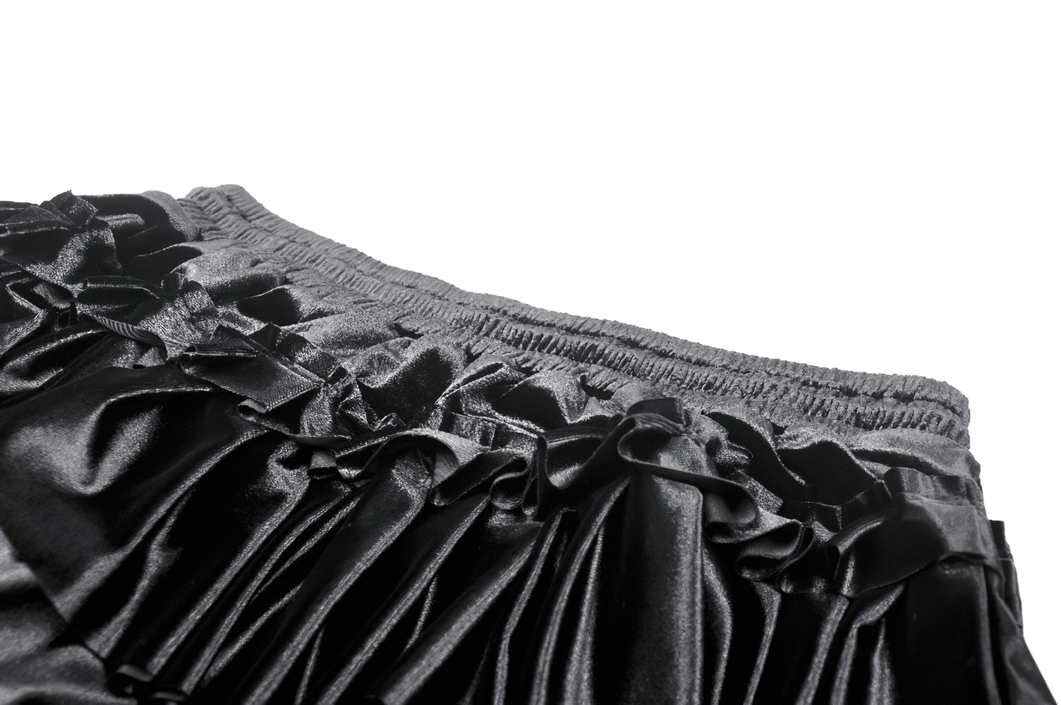 Close-up of black velvet frilly layered mini skirt with delicate lace trim and ruffled tiers for a stylish look.