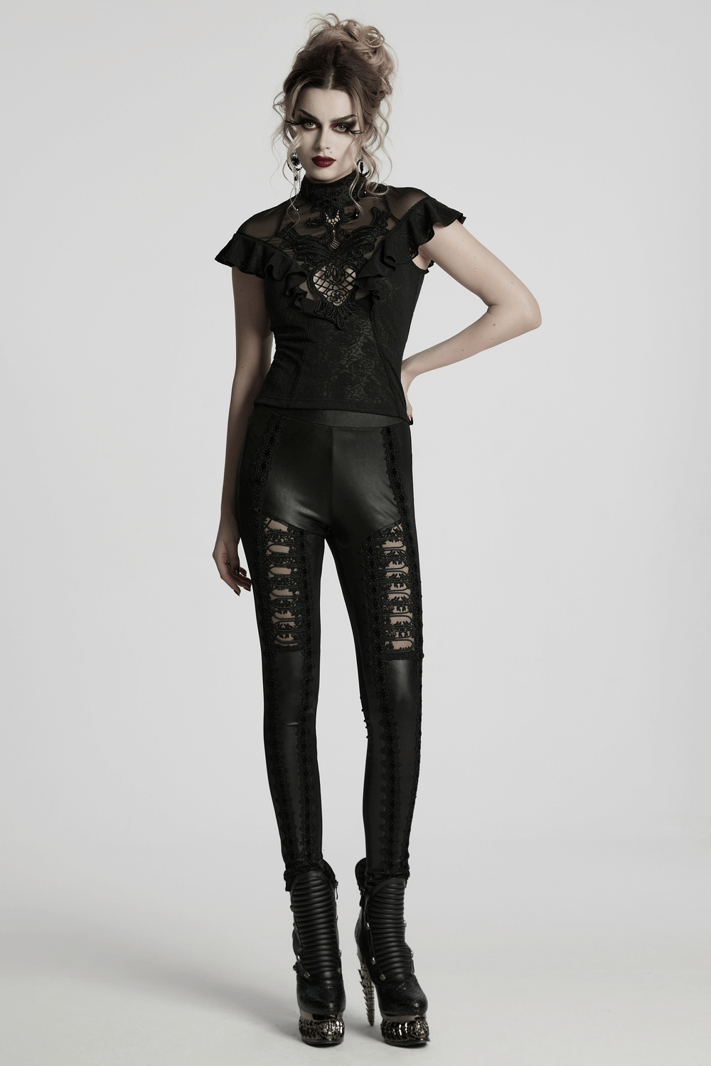 Gothic style female model wearing glossy black lace spliced leggings, showcasing a chic and edgy fashion statement.