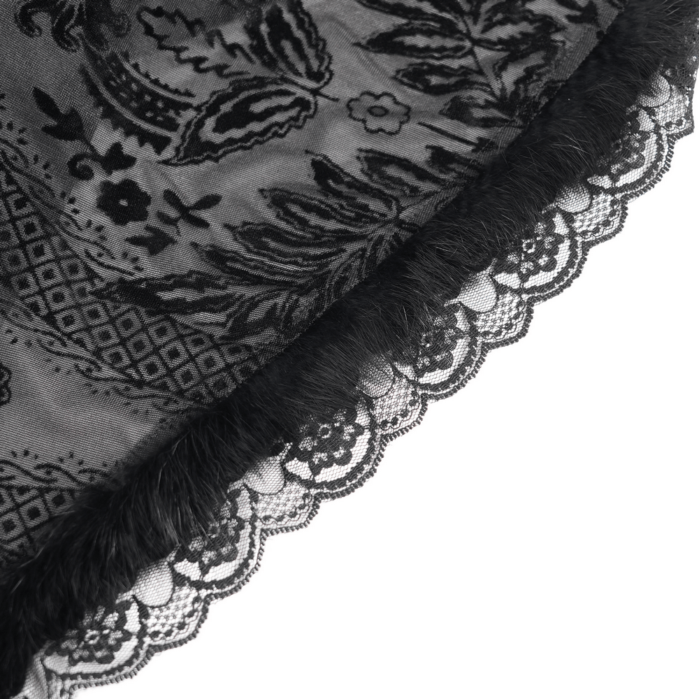 Close-up of intricate black lace trim on gothic dress showcasing delicate floral patterns and velvety texture.