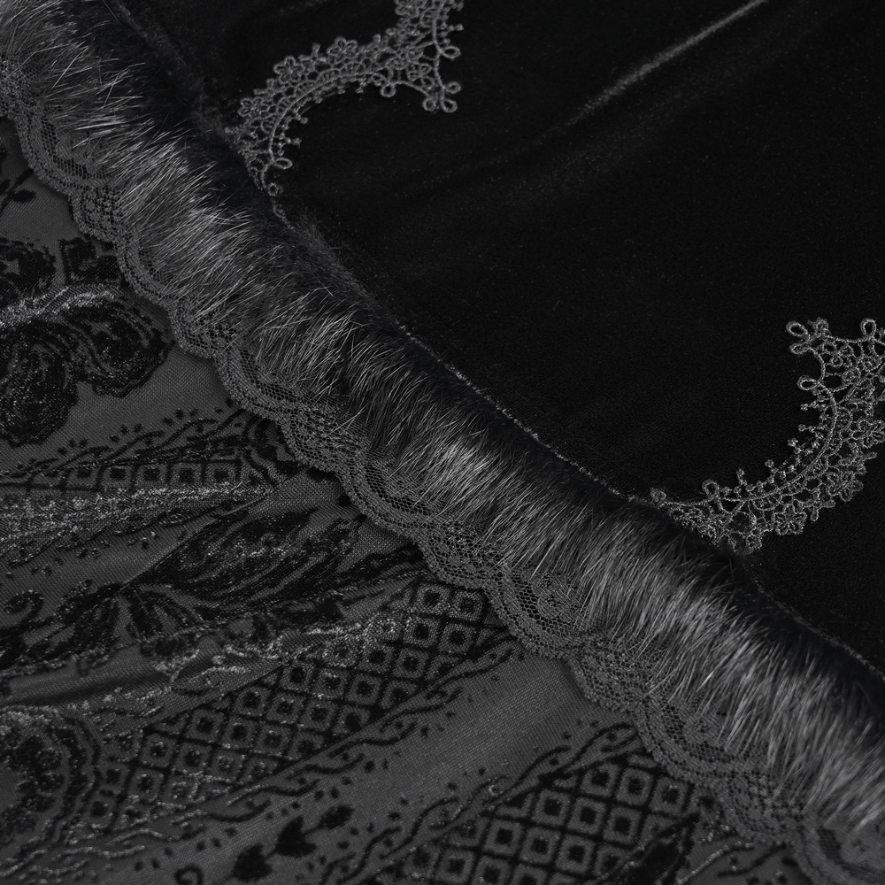 Close-up of black velvet fabric with lace trim, showcasing intricate embroidery and gothic elegance details.