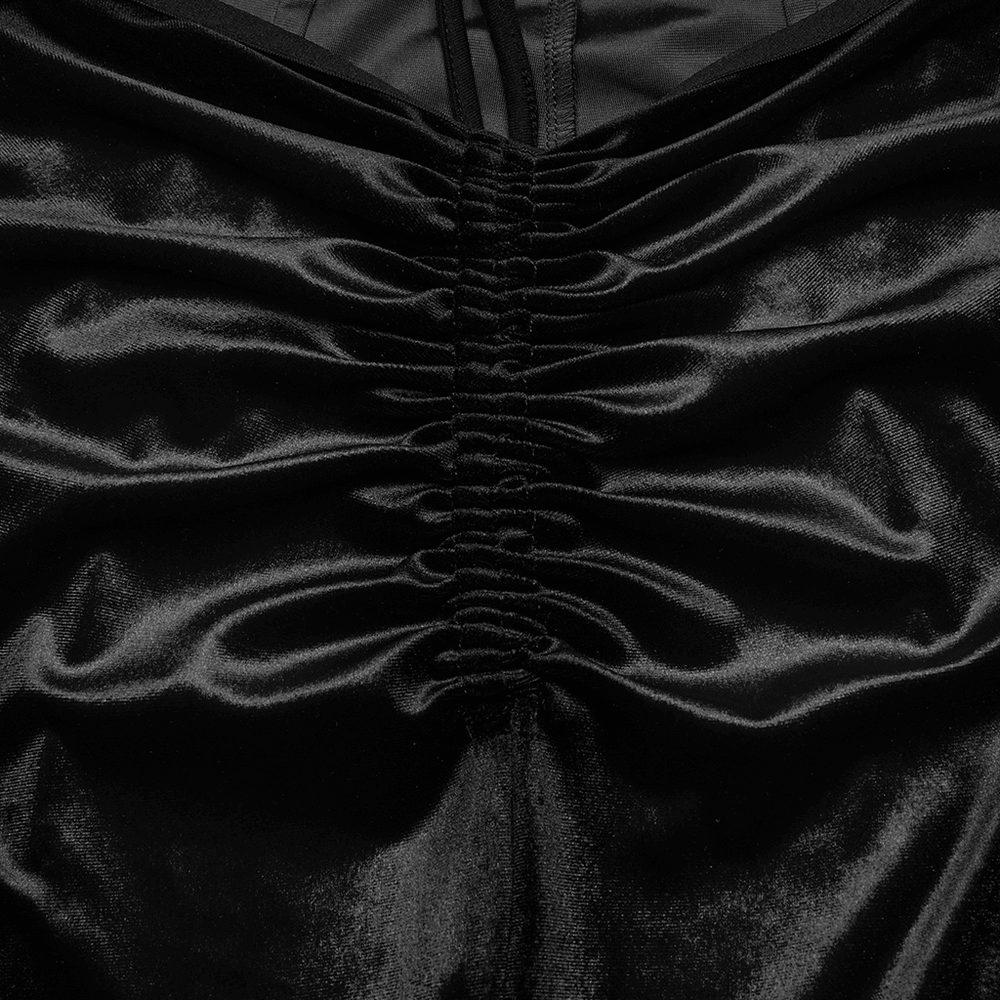 Close-up of black velvet flared pants showcasing gathered waist design, perfect for a goth-inspired look.