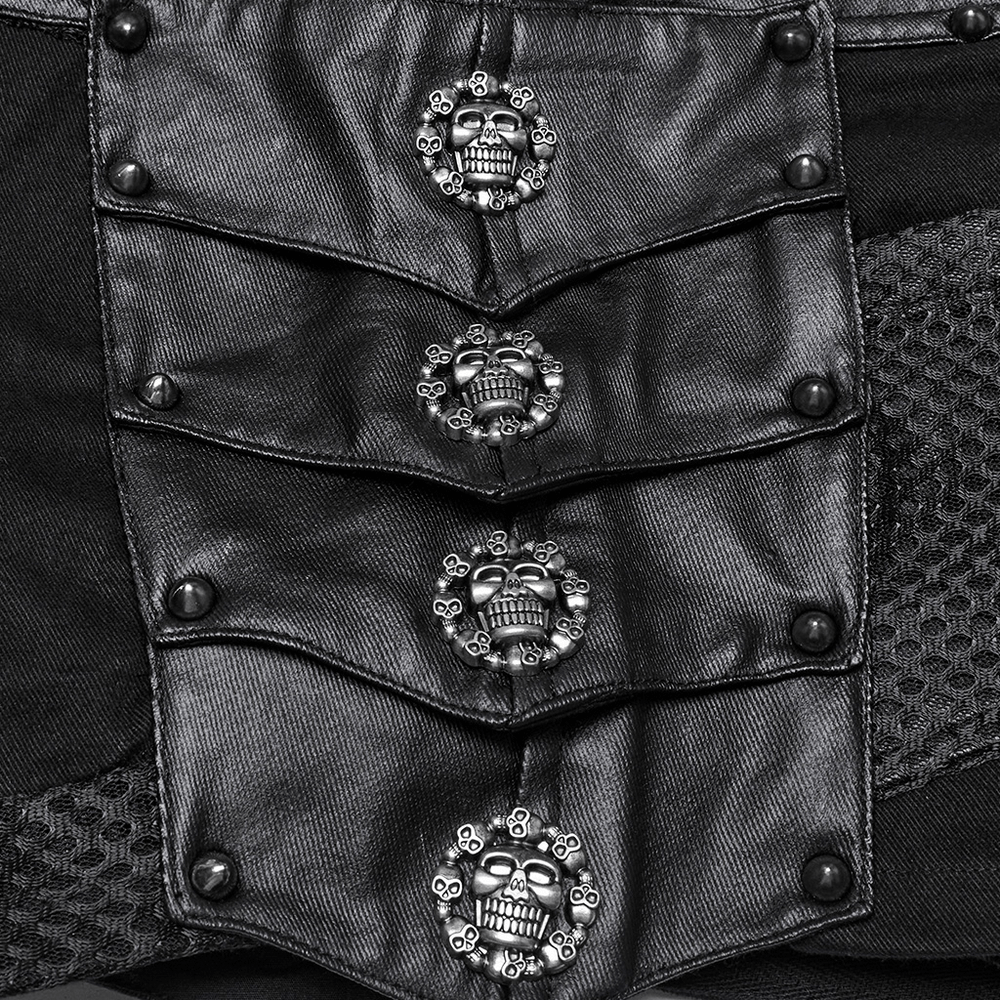 Close-up of black fabric featuring skull studs for gothic punk shorts design.
