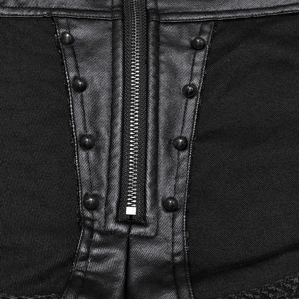 Close-up of zipper and buckle details on female gothic black studded high waist mesh shorts.