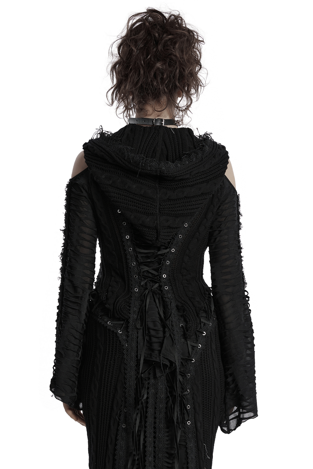 Back view of a female model wearing a gothic hooded knit jacket with tassels and cold shoulder design.