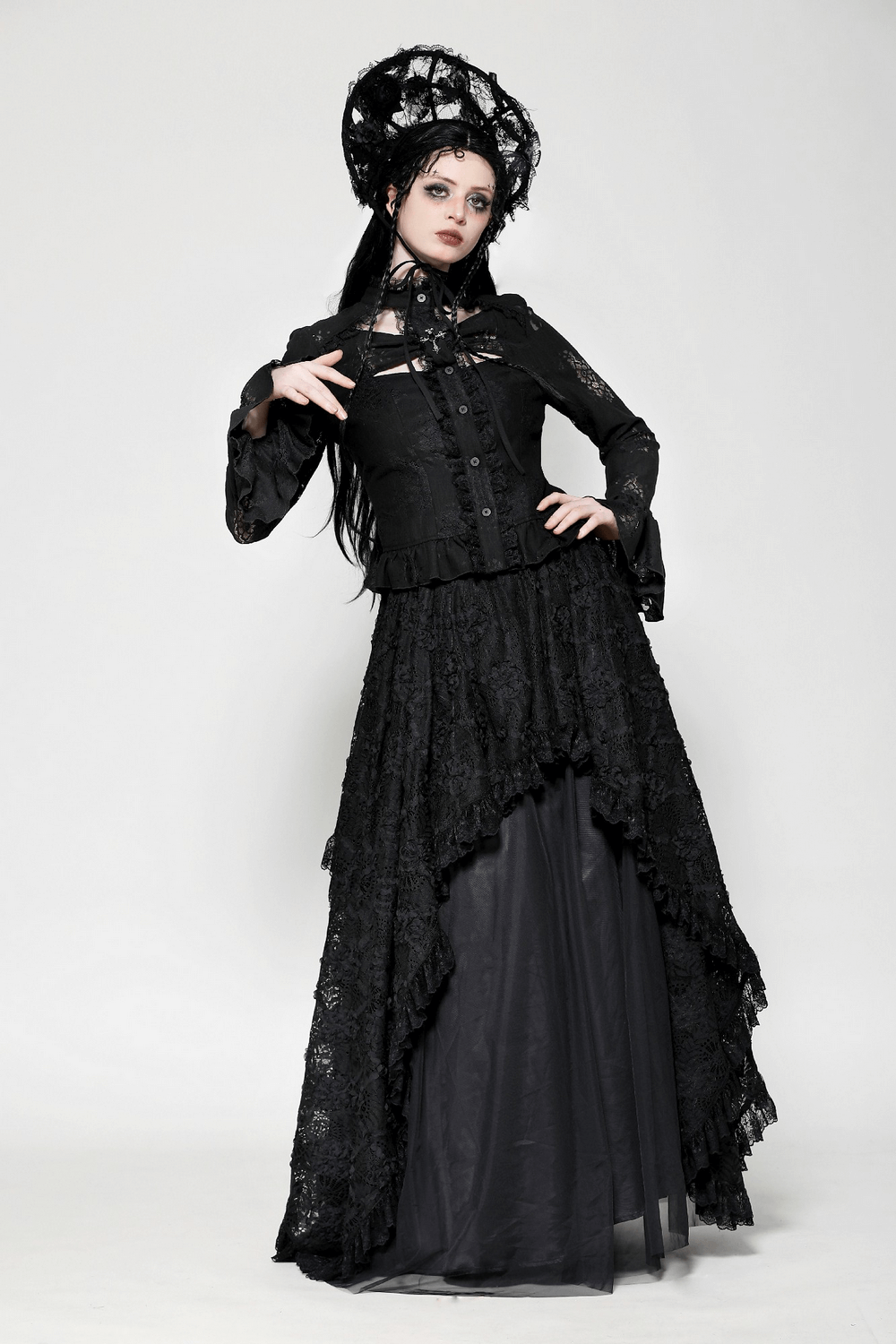 Woman in a stunning black Gothic lace blouse with bell sleeves and a dramatic skirt, exuding dark elegance and mystery.