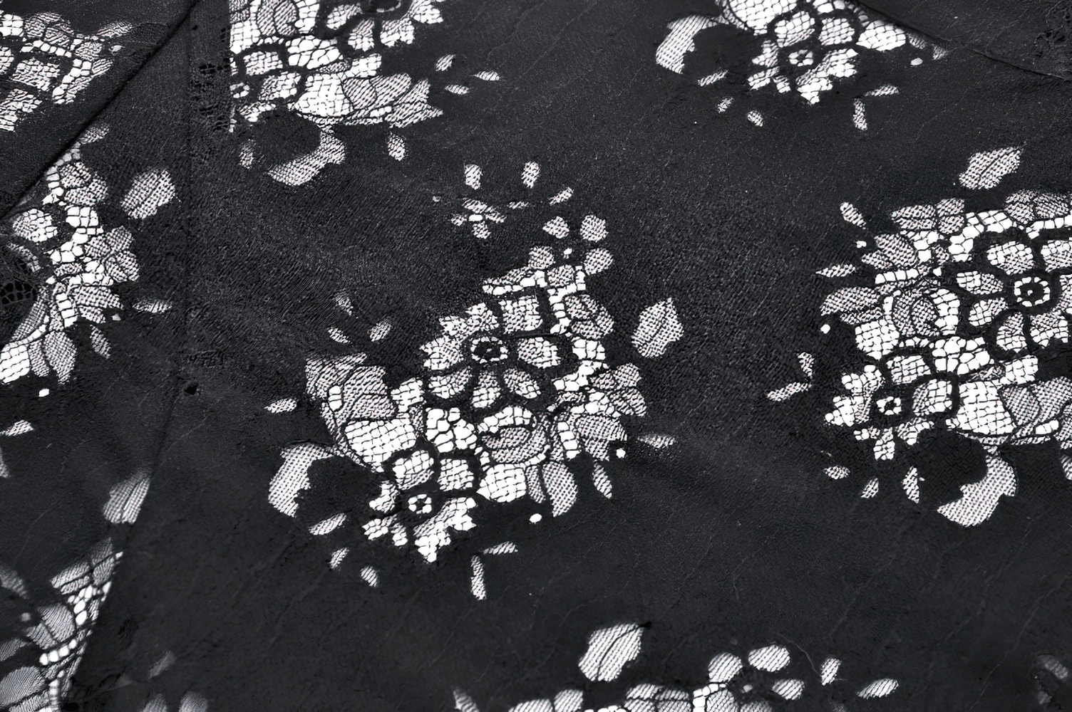 Close-up of intricate black lace fabric with floral patterns, perfect for a gothic lace blouse design.