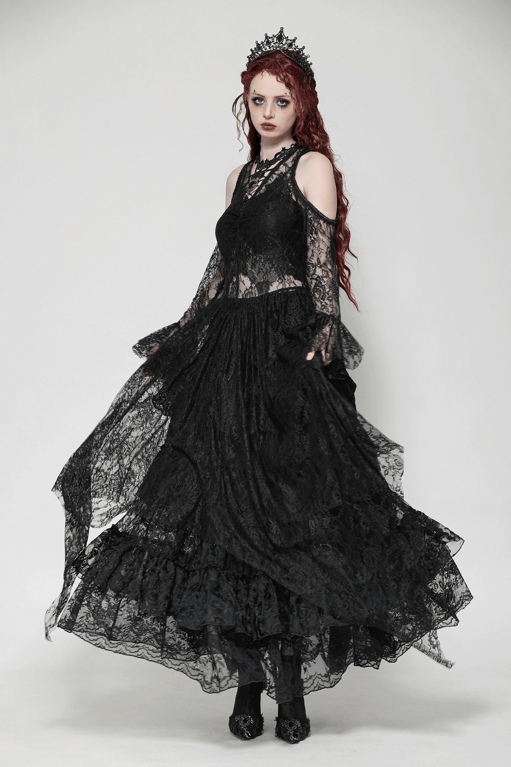 Elegant female in a black Gothic lace overlay maxi dress with sleeves, showcasing Victorian elegance and modern charm.