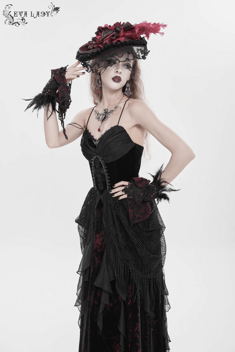 Female Gothic Lace-Up Dress with Ruffled Tulle Layers worn by a model, featuring intricate fringes and a dramatic silhouette.