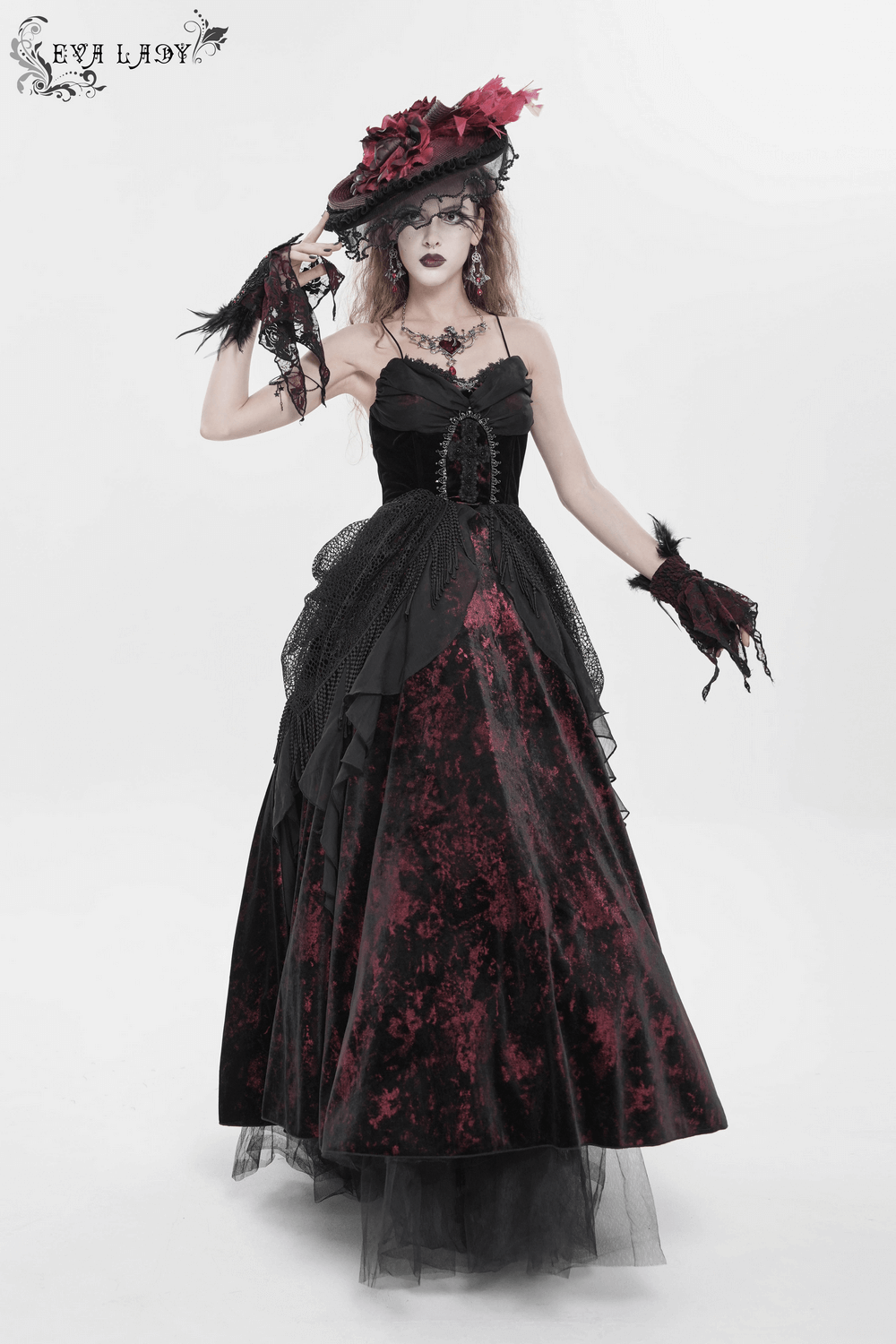 Female Gothic Lace-Up Dress with Ruffled Tulle Layers model wearing vintage black dress with off-shoulder design and dramatic flare.