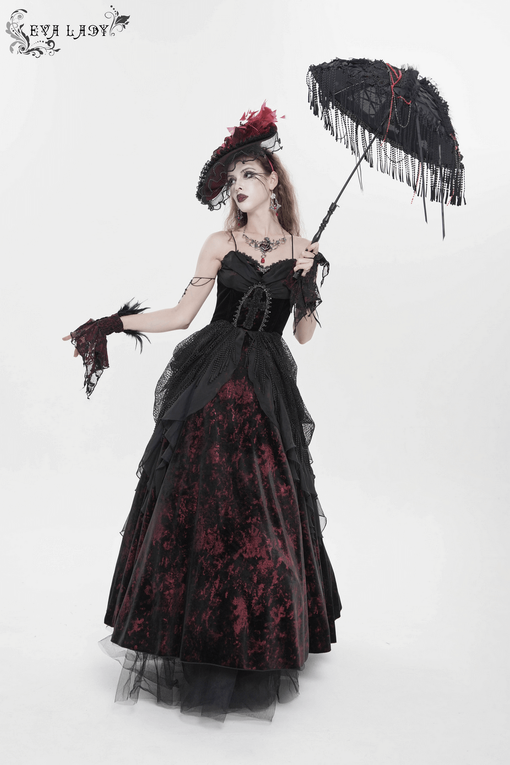 Female Gothic Lace-Up Dress with Ruffled Tulle Layers worn by a model holding a parasol, featuring vintage black velvet fabric.