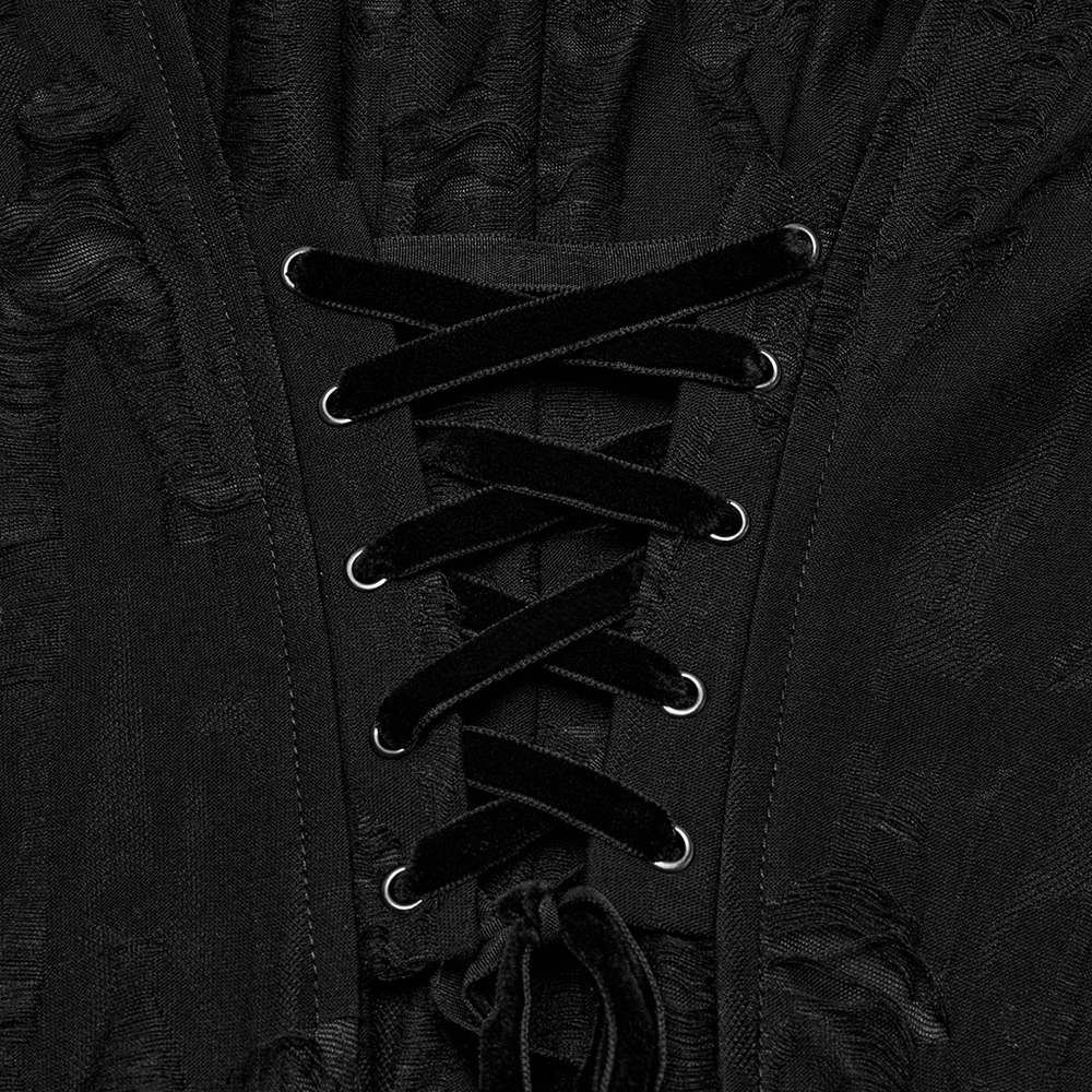 Close-up of a gothic black coat's lace-up front with velvet cords and metal eyelets, showcasing intricate design details.