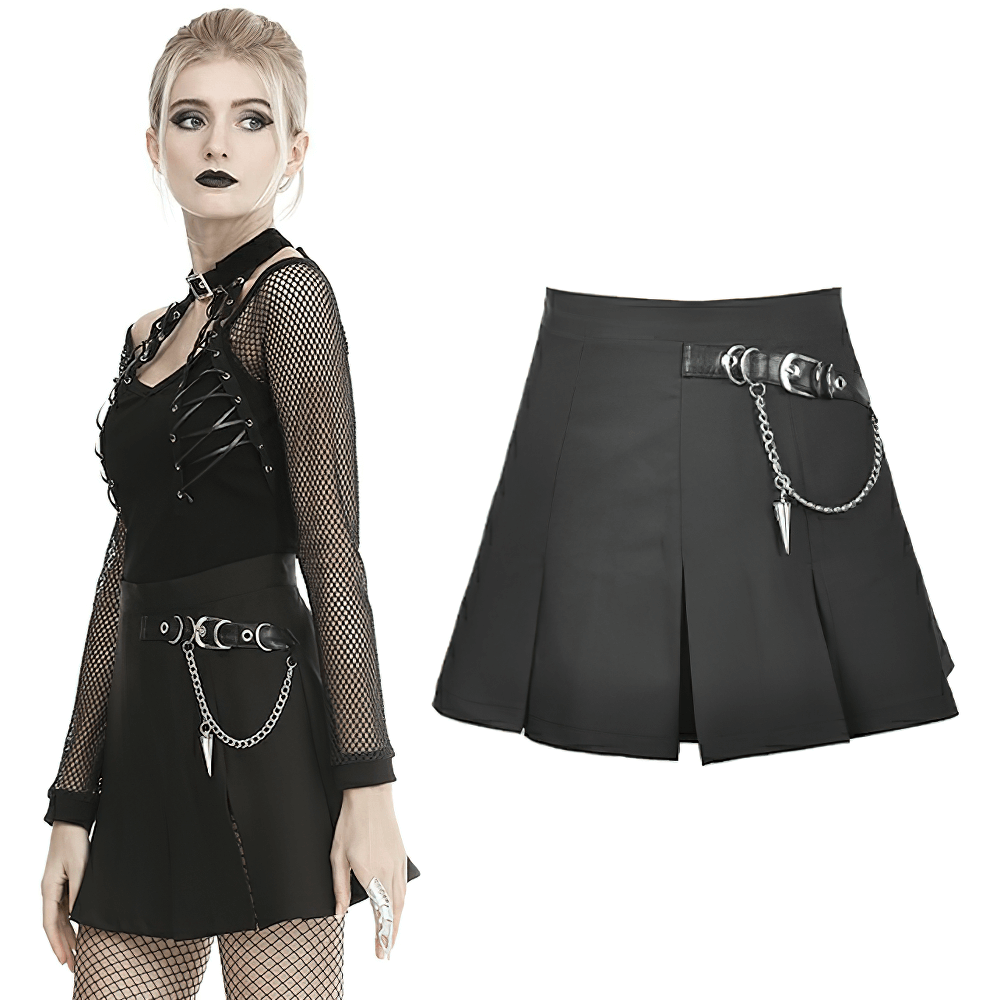 Black pleated mini skirt with chain detail, paired with edgy gothic style and mesh top.