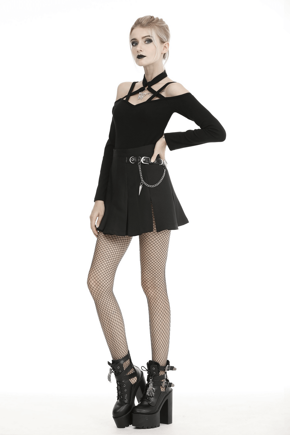 Gothic black pleated mini skirt with chain detail, paired with fishnet stockings and chunky boots for a bold look.