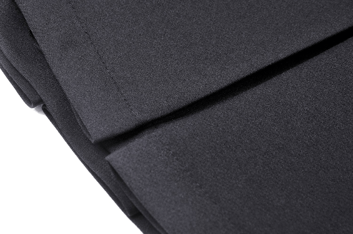 Close-up of black pleated fabric, highlighting the texture and details of a gothic mini skirt.
