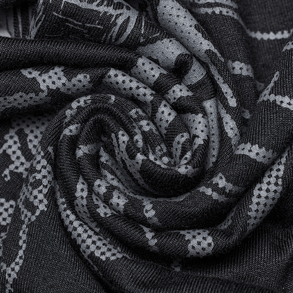 Close-up of elastic knitted fabric with gothic skeleton print in black and gray, showcasing punk style.