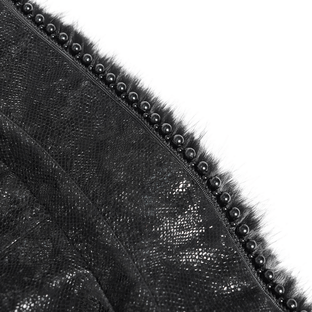 Close-up of black fabric with faux fur trim and decorative buckle details, showcasing gothic fashion elegance.