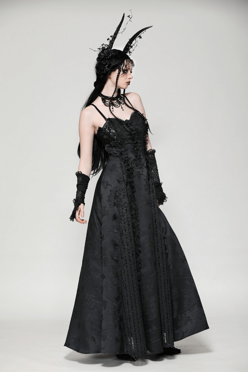 Elegant female in a black lace gothic maxi dress, showcasing floral embroidery and intricate details, perfect for Victorian-inspired events.