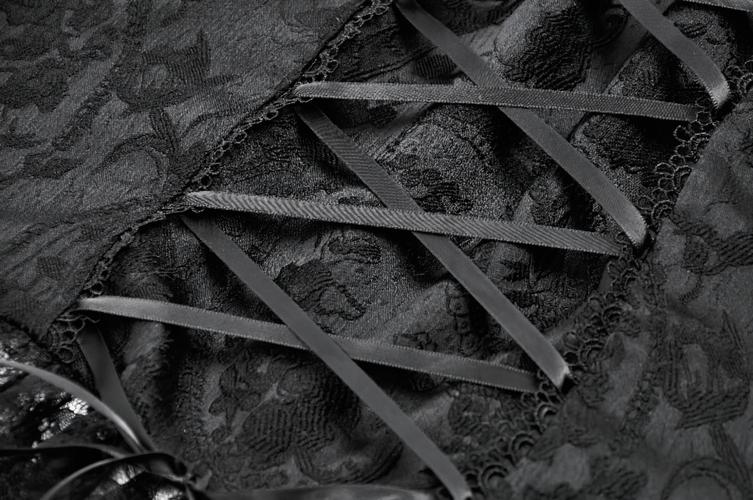 Close-up of a gothic lace top with a corset back and elegant ribbon detailing.