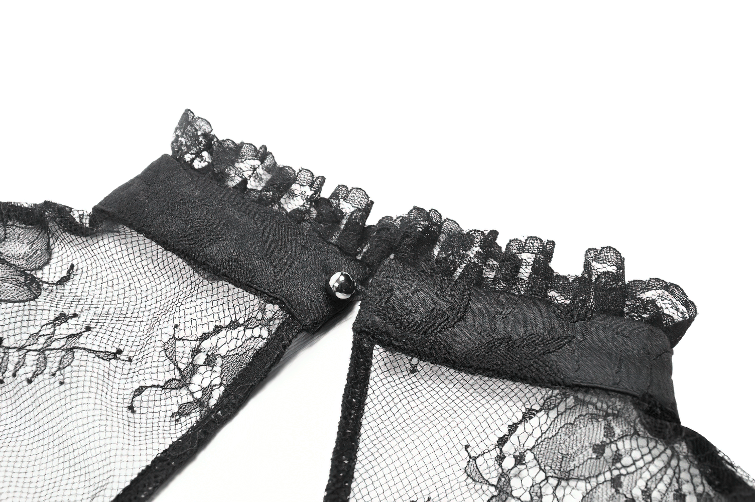 Close-up of elegant black lace collar with ruffled edges and gemstone brooch detailing.
